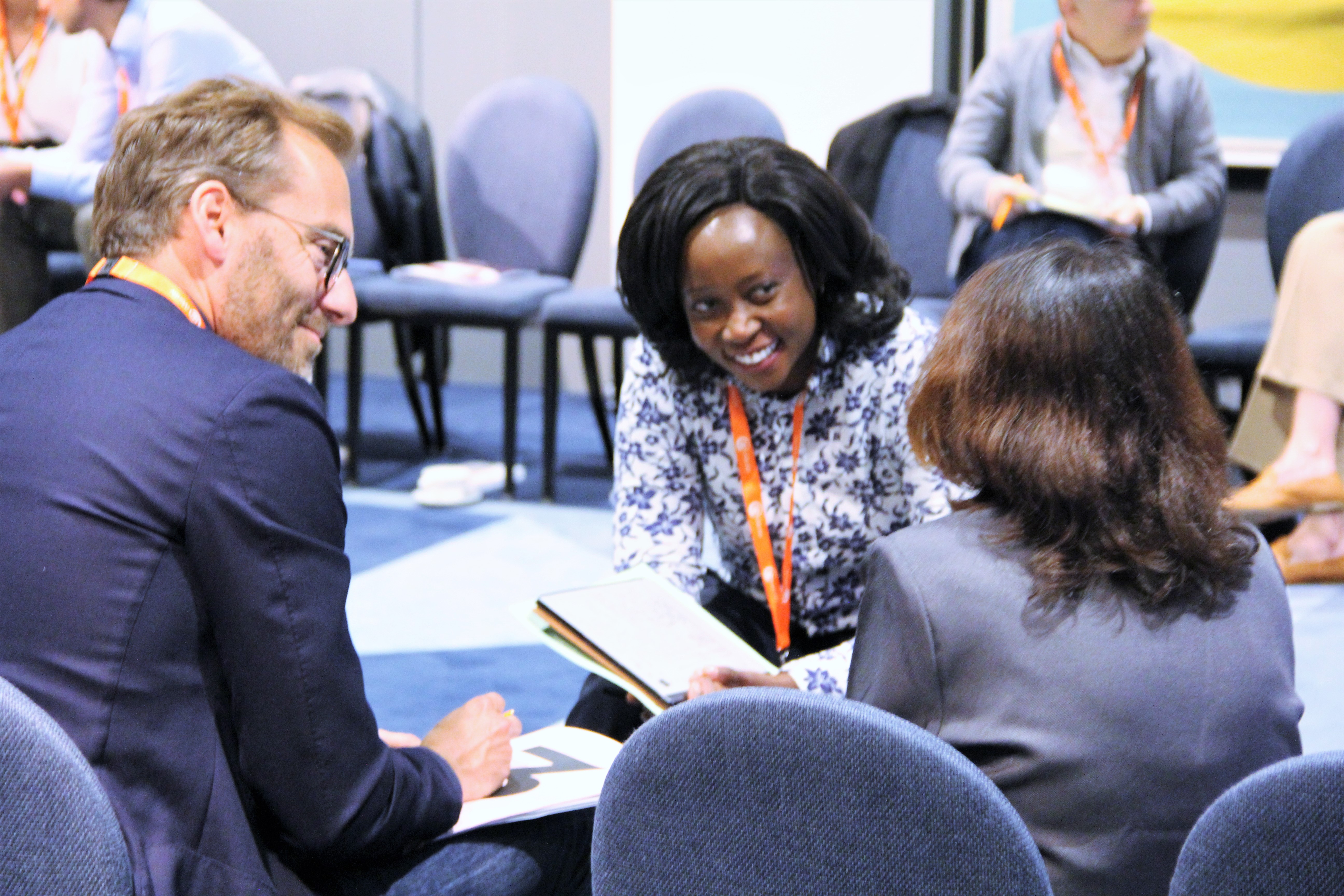 Three participants in conversation at an iVentiv event in 2022